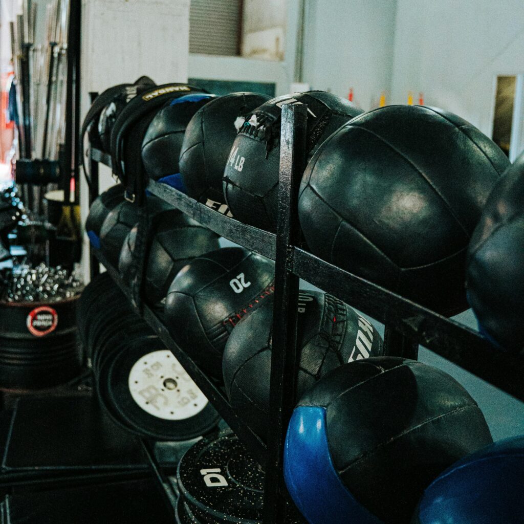 Medicine balls neatly arranged in an indoor gym, ideal for fitness routines and workouts.