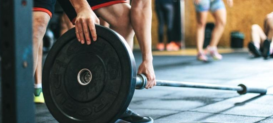 a man holding a barbell 
